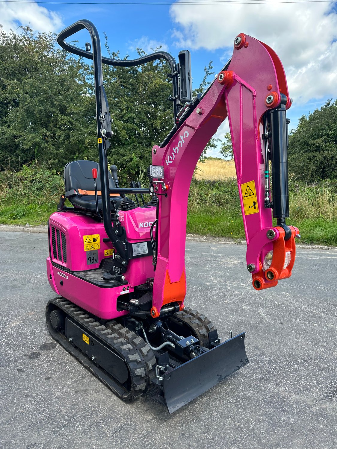 Kubota pink K008-5 micro digger from right side