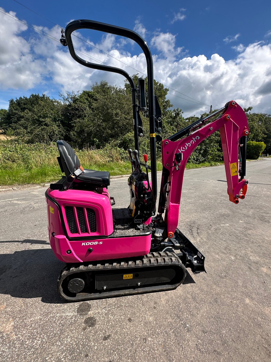 Kubota pink K008-5 micro digger side on