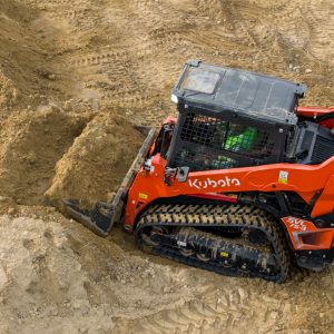 Kubota SVL75-3 skid steer digging dirt
